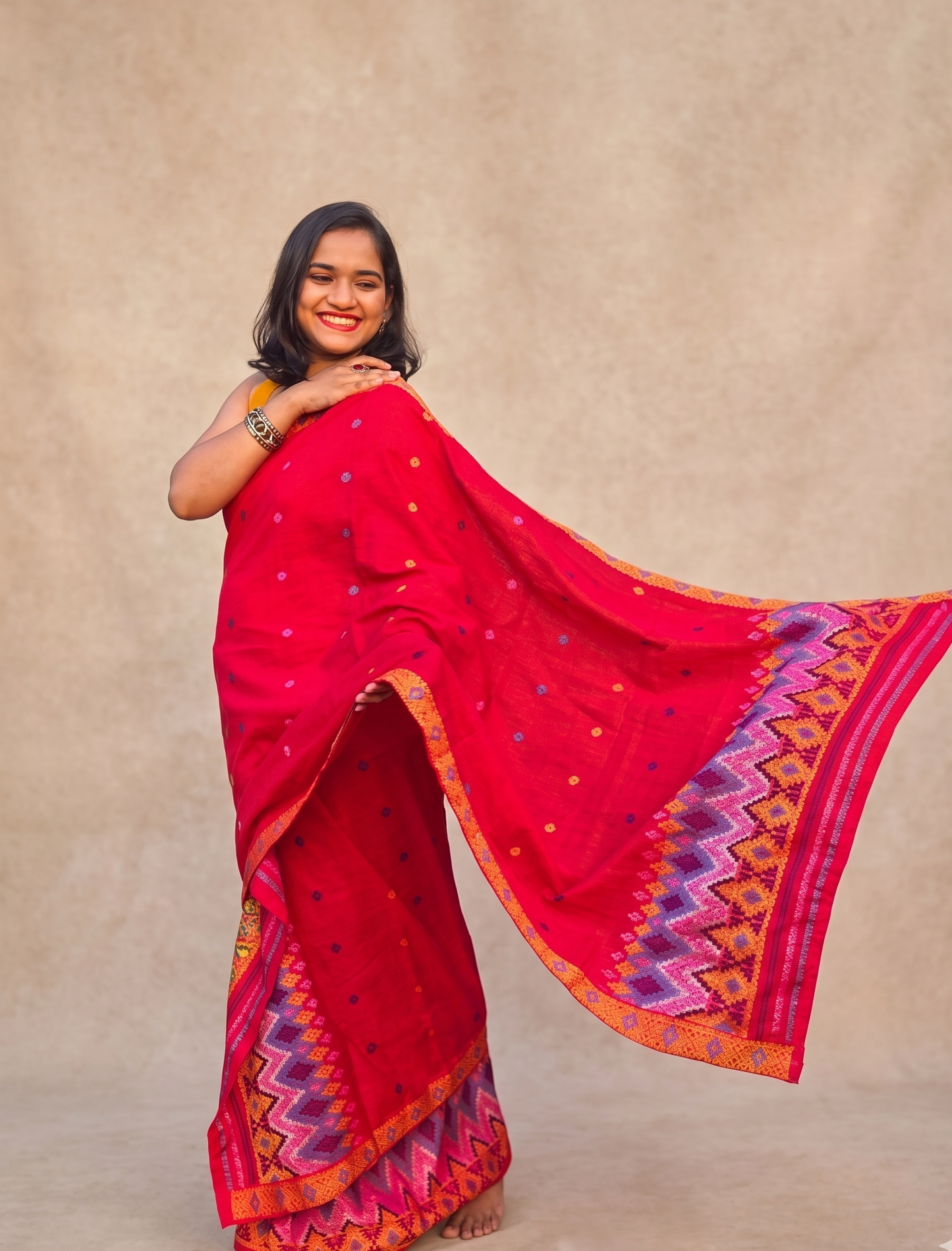 Full length look of fully stitched red Assam cotton Mishing Mekhela Chador