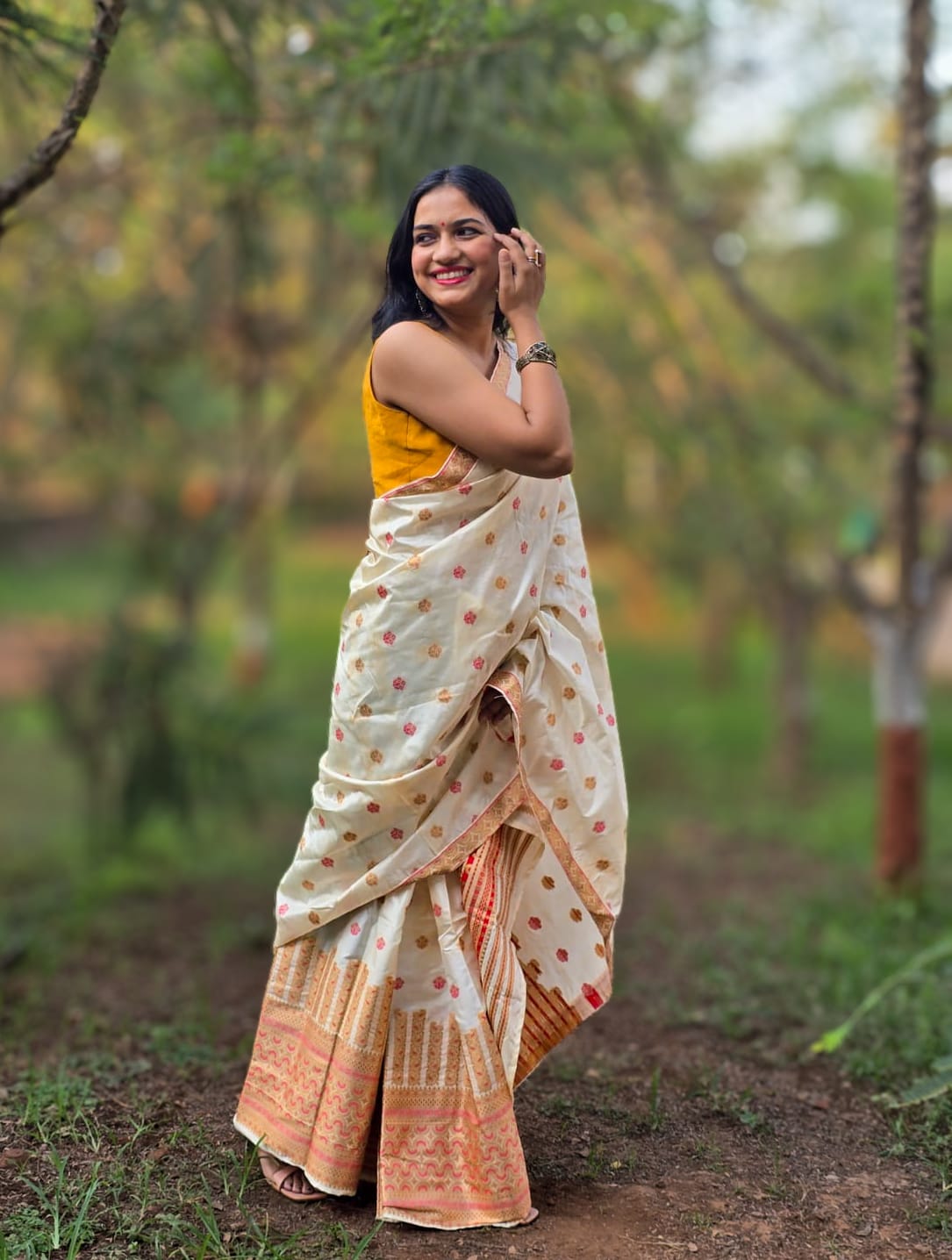 Handwoven cream silk Mekhela Chador from Assam with golden zari woven border