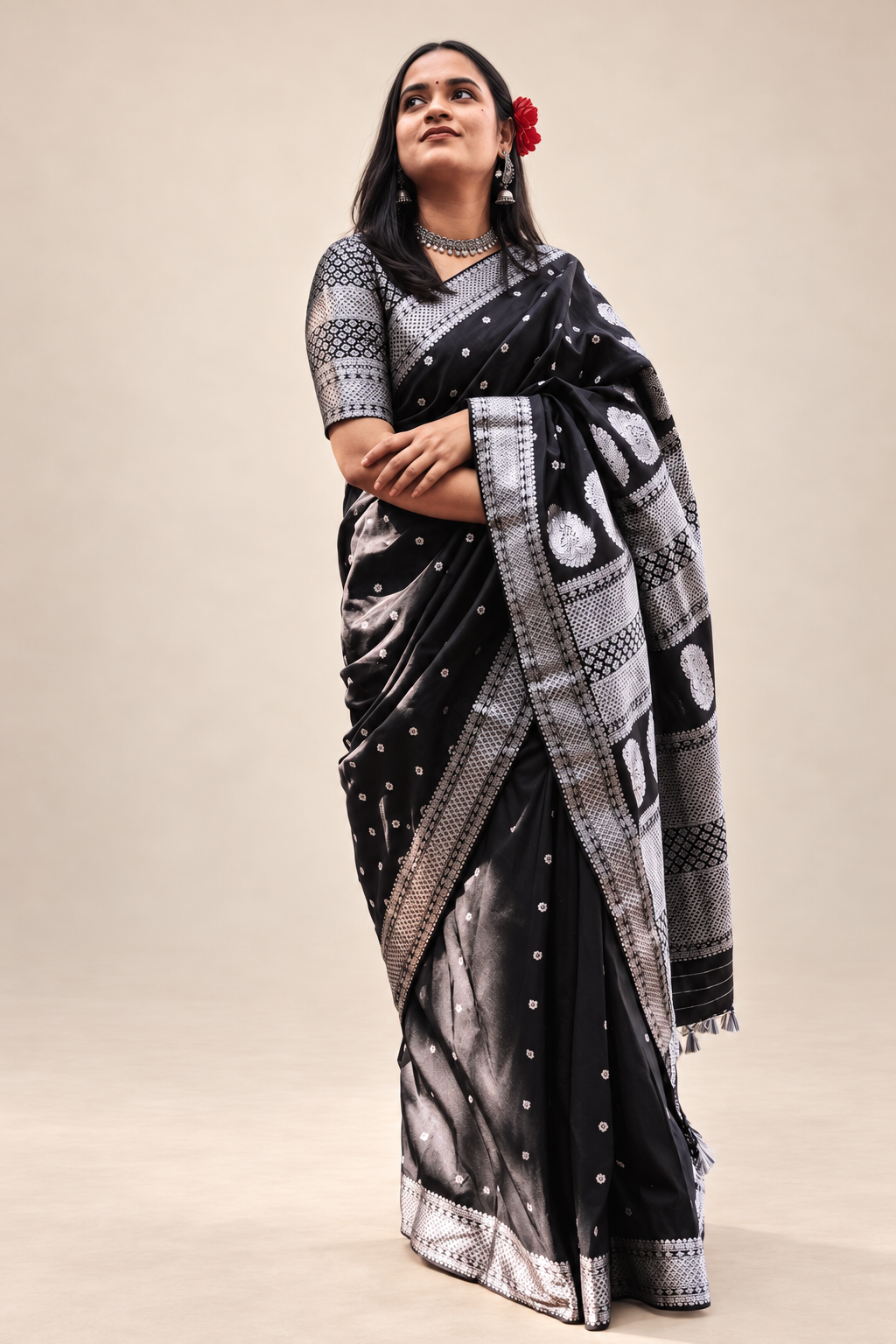Black saree with silver woven border, paisley motifs and geometric detailing styled for festive and cultural occasions.
