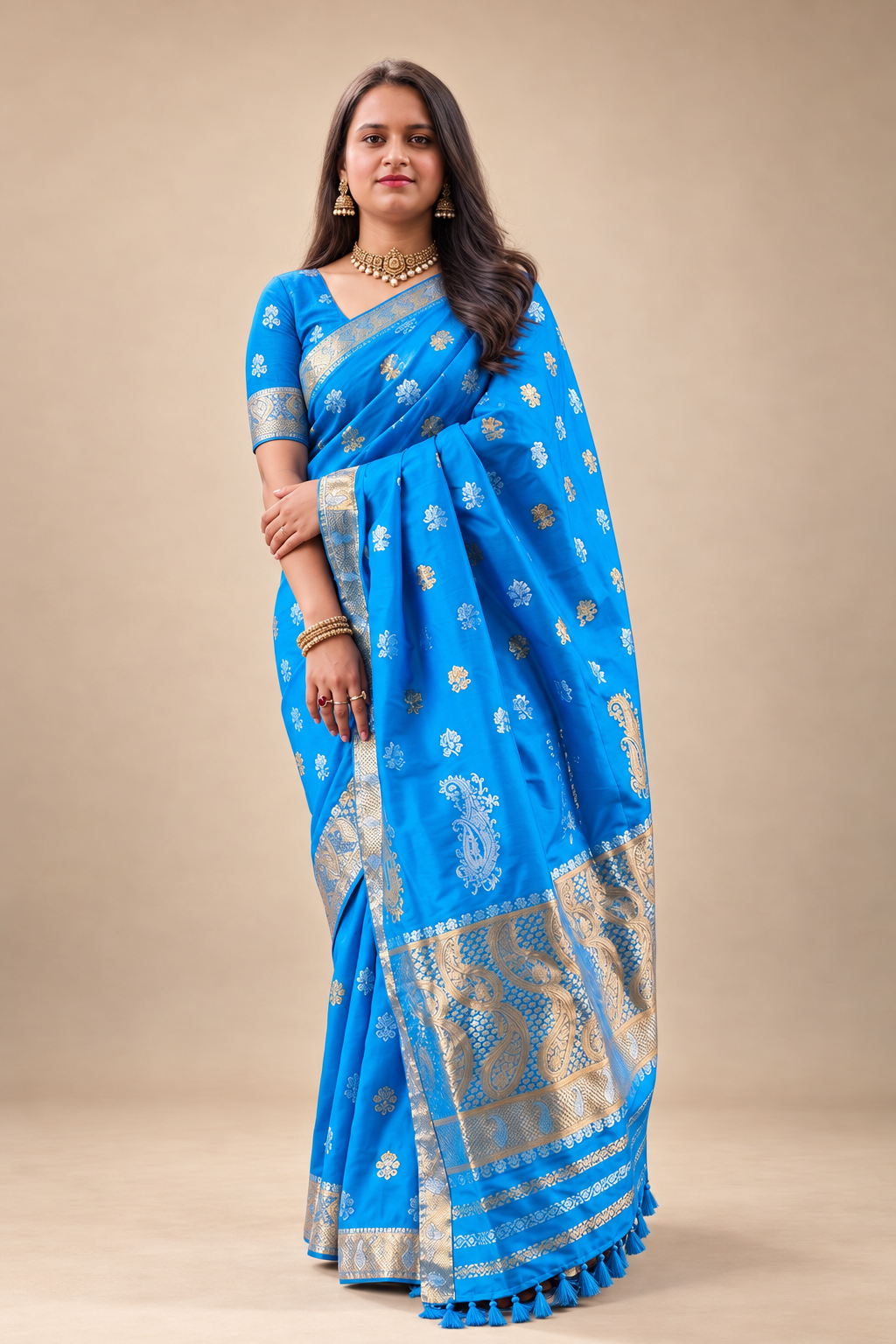 Bright blue silk saree with gold zari border, woven motifs and ornate paisley detailing for wedding and festive wear.
