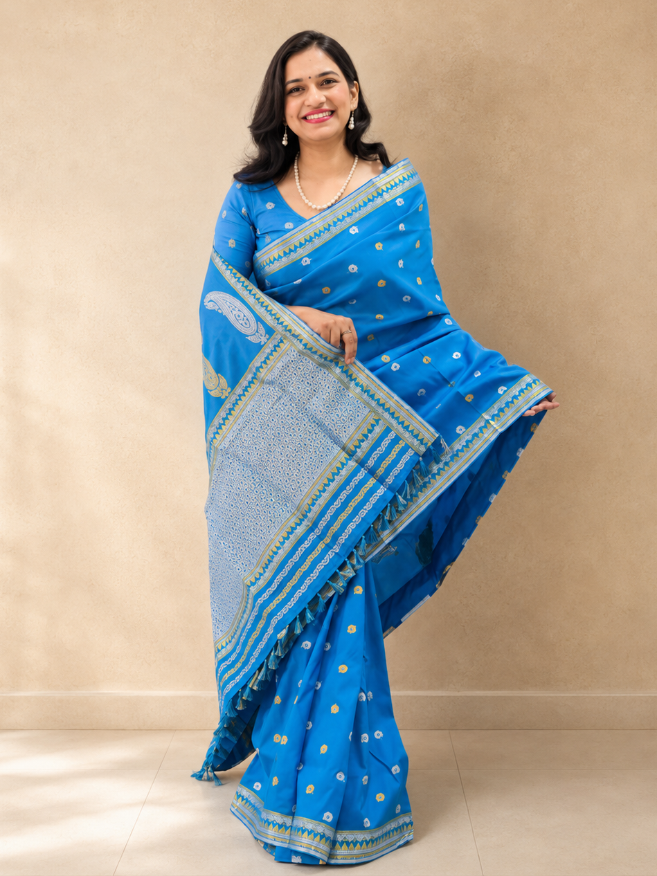 Full drape of a blue saree featuring silver paisley motifs, detailed patterned pallu and tassel finish.