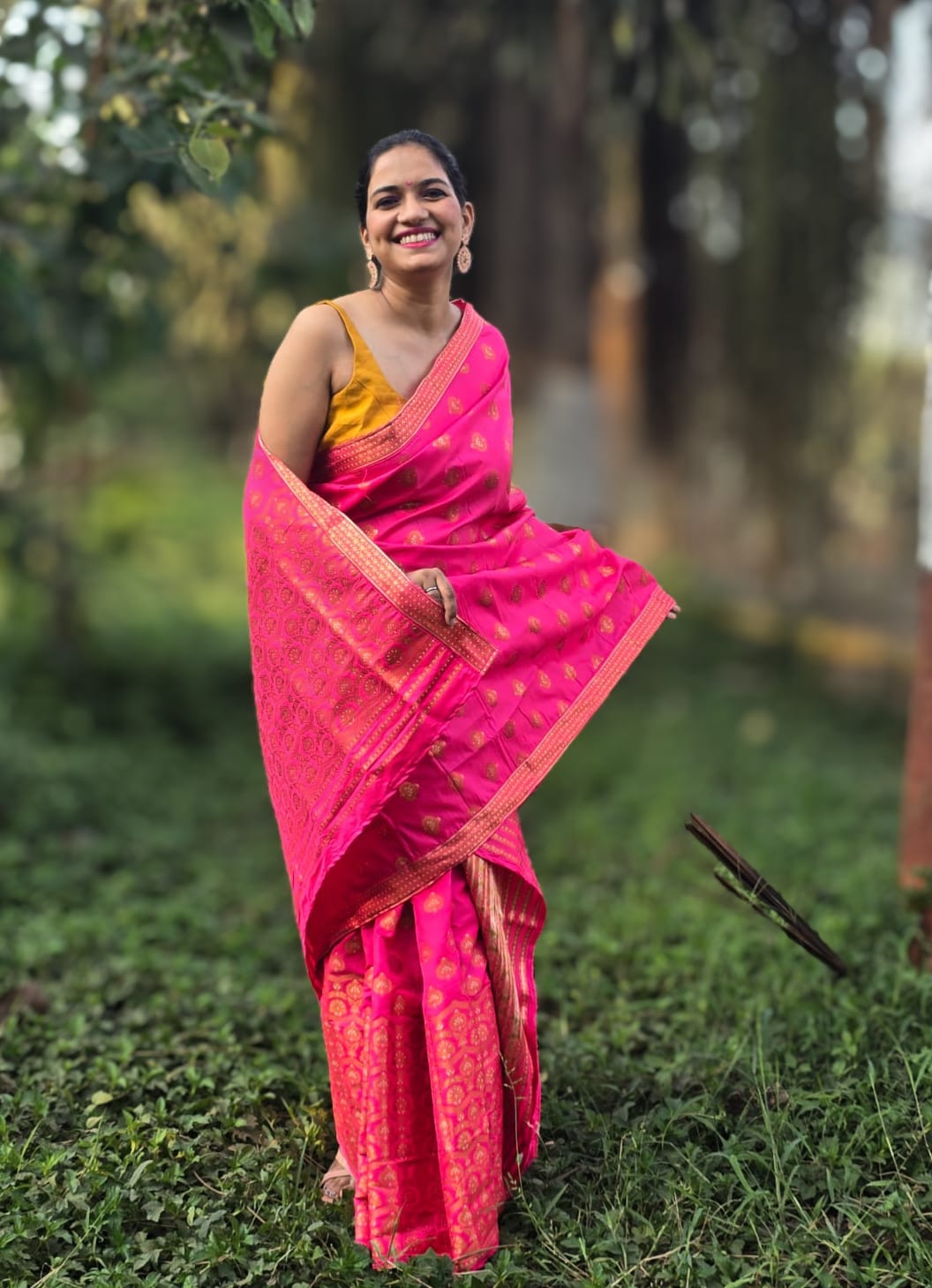 Handwoven rani pink silk Mekhela Chador from Assam with golden woven motifs and border