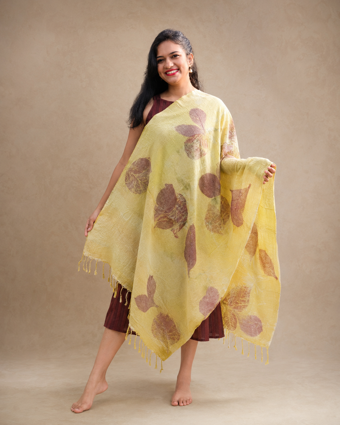Soft yellow handwoven stole from Assam with botanical leaf impressions