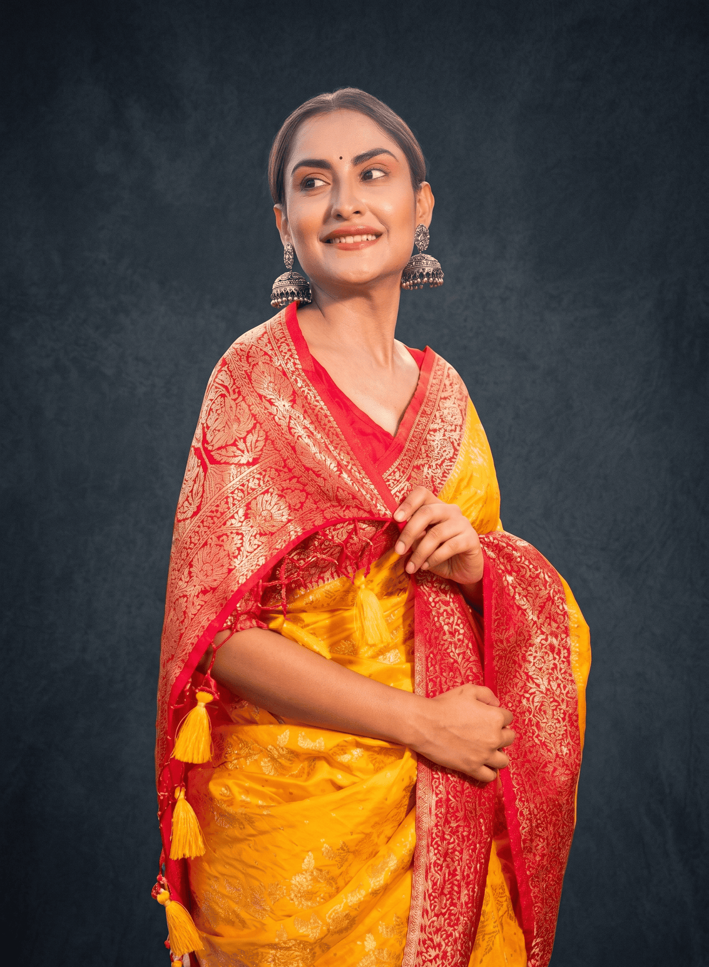 Angled full view of Madhurima yellow Banarasi silk jacquard saree for family functions and celebrations