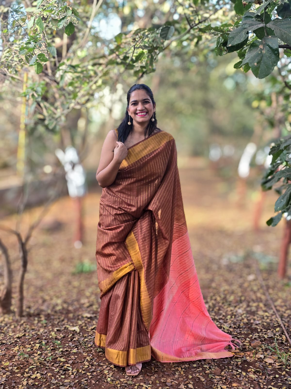 Mati Rekha brown silk cotton saree with zari border and coral pallu inspired by Assam