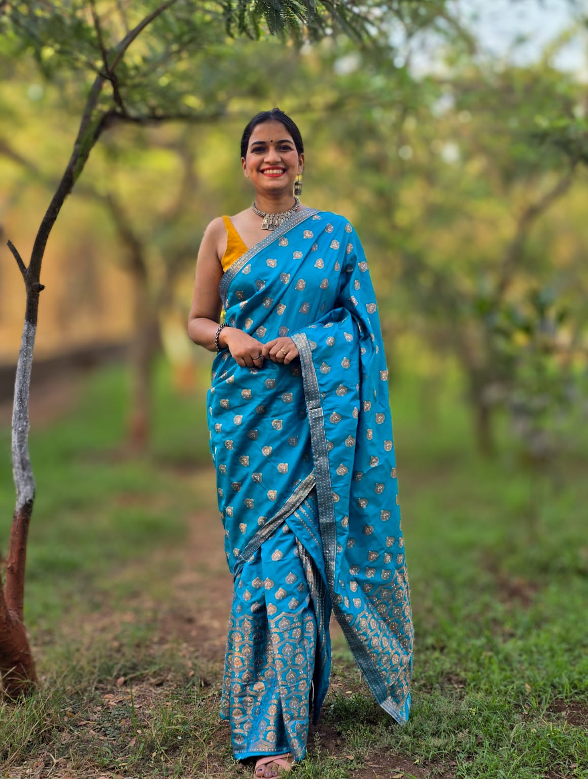 Handwoven teal blue mixed silk Mekhela Chador from Assam with golden woven motifs
