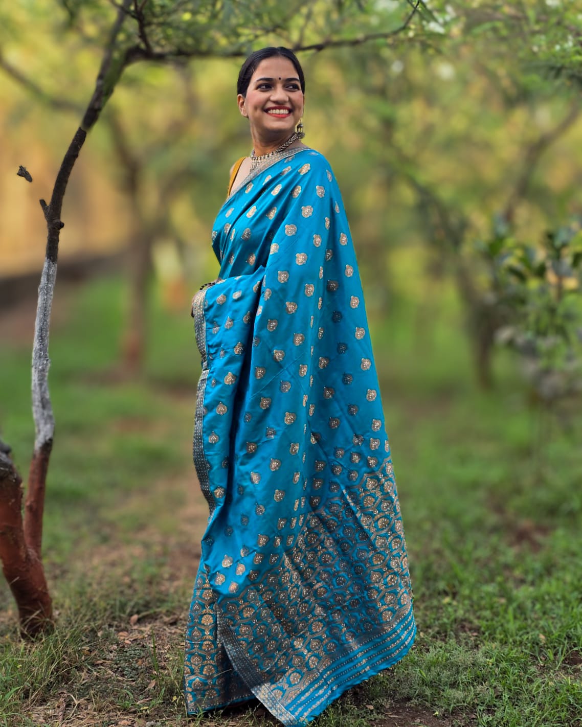 Handwoven teal blue mixed silk Mekhela Chador from Assam with golden woven motifs