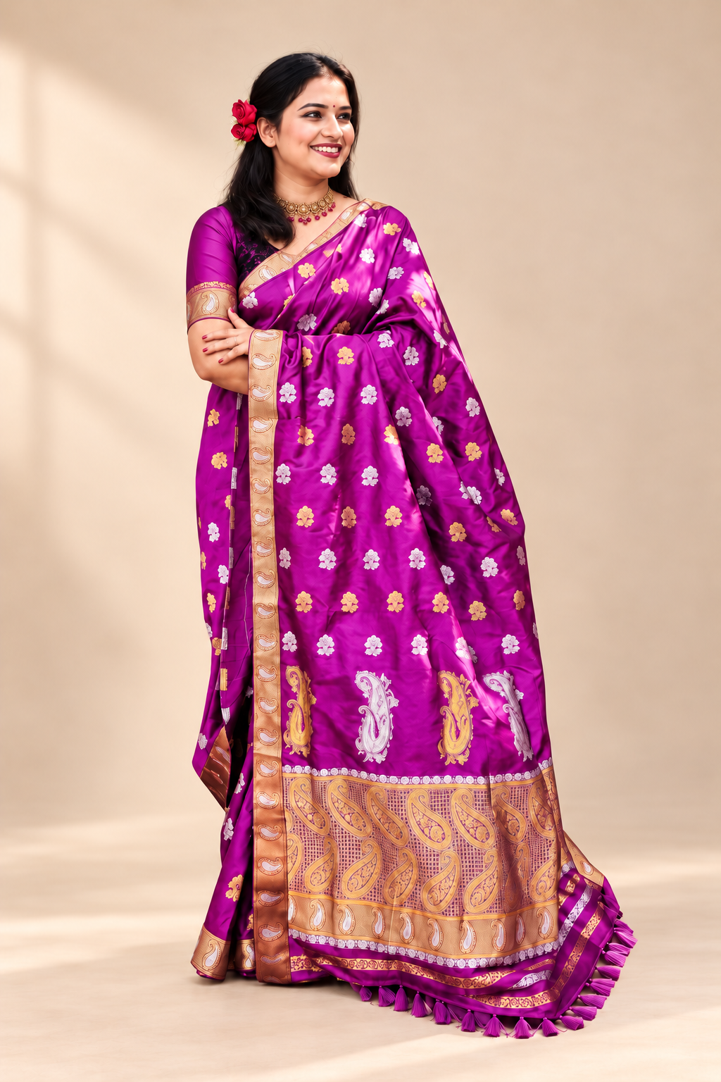Full drape of a rich purple silk saree with gold woven motifs, zari border and traditional festive detailing.