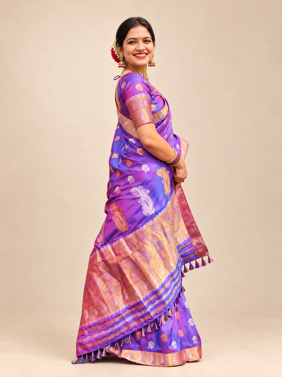 Purple silk saree with gold zari border, woven floral motifs and ornate paisley detailing for weddings and festive occasions.
