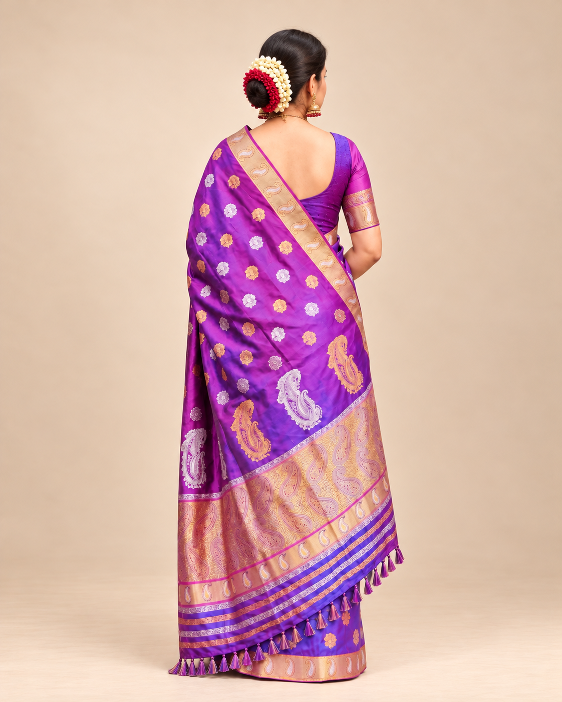 Back view of a traditional purple silk saree with gold zari border, paisley motifs and festive woven detailing.