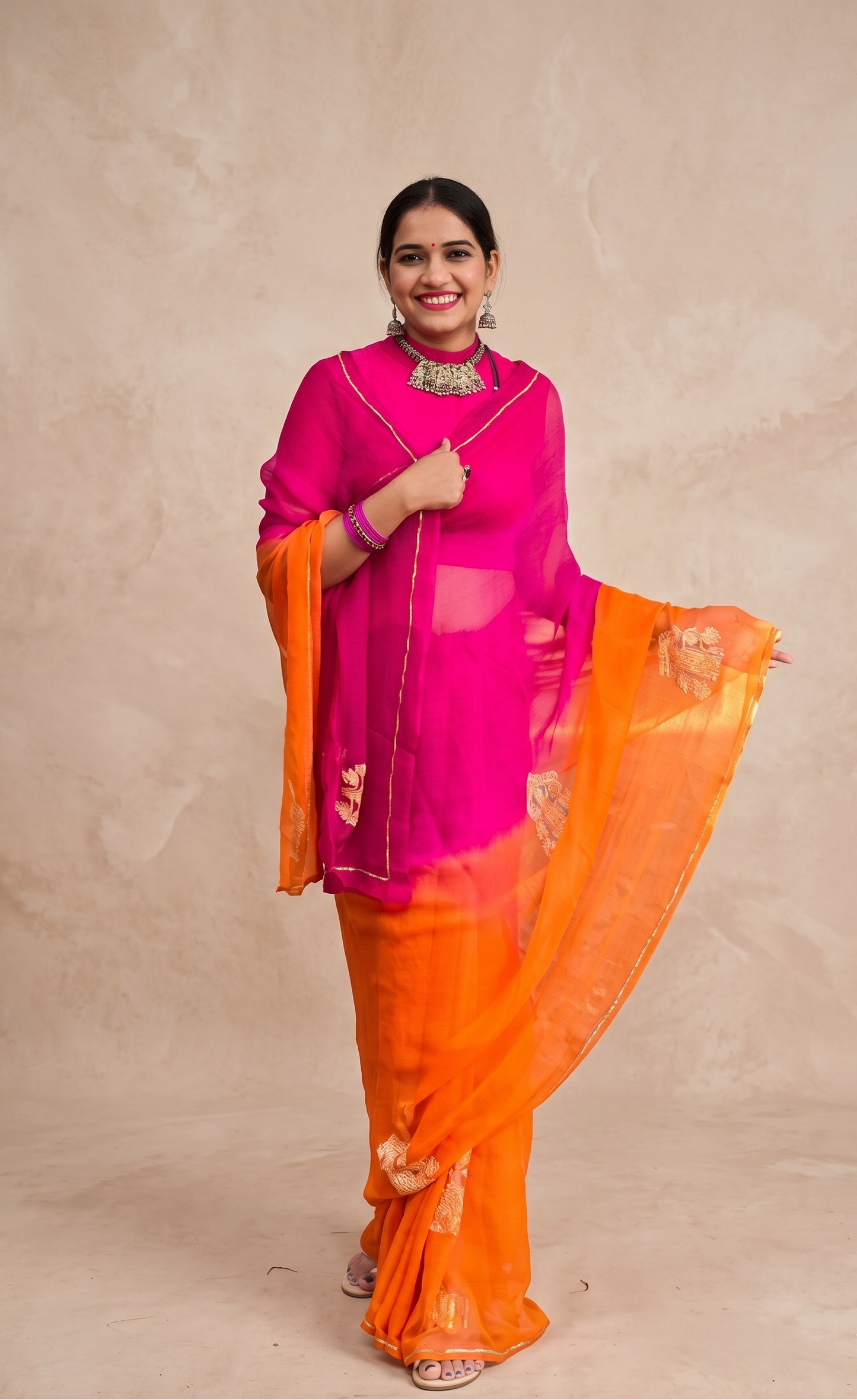 Rangilo Assam pink orange chiffon saree with Assam-inspired Gos motif for festive wear