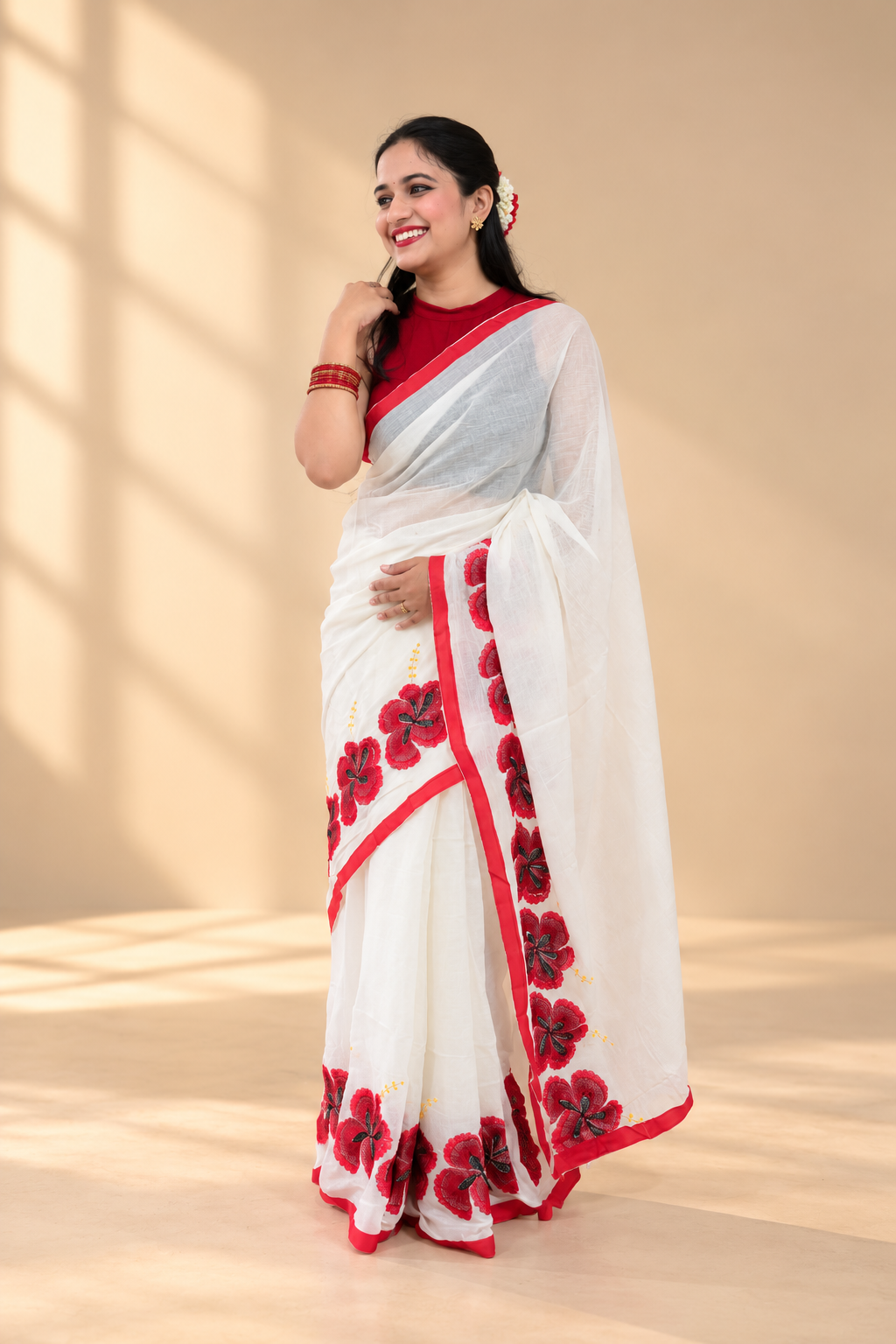 Ronga Joba festive white saree with red border and red hibiscus floral motifs.