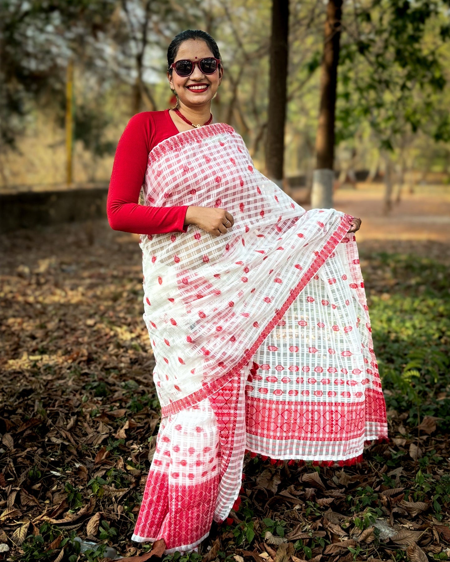 White and red cotton Mekhela Chador from Assam with traditional woven motifs, ideal for Bihu and Assamese festive wear