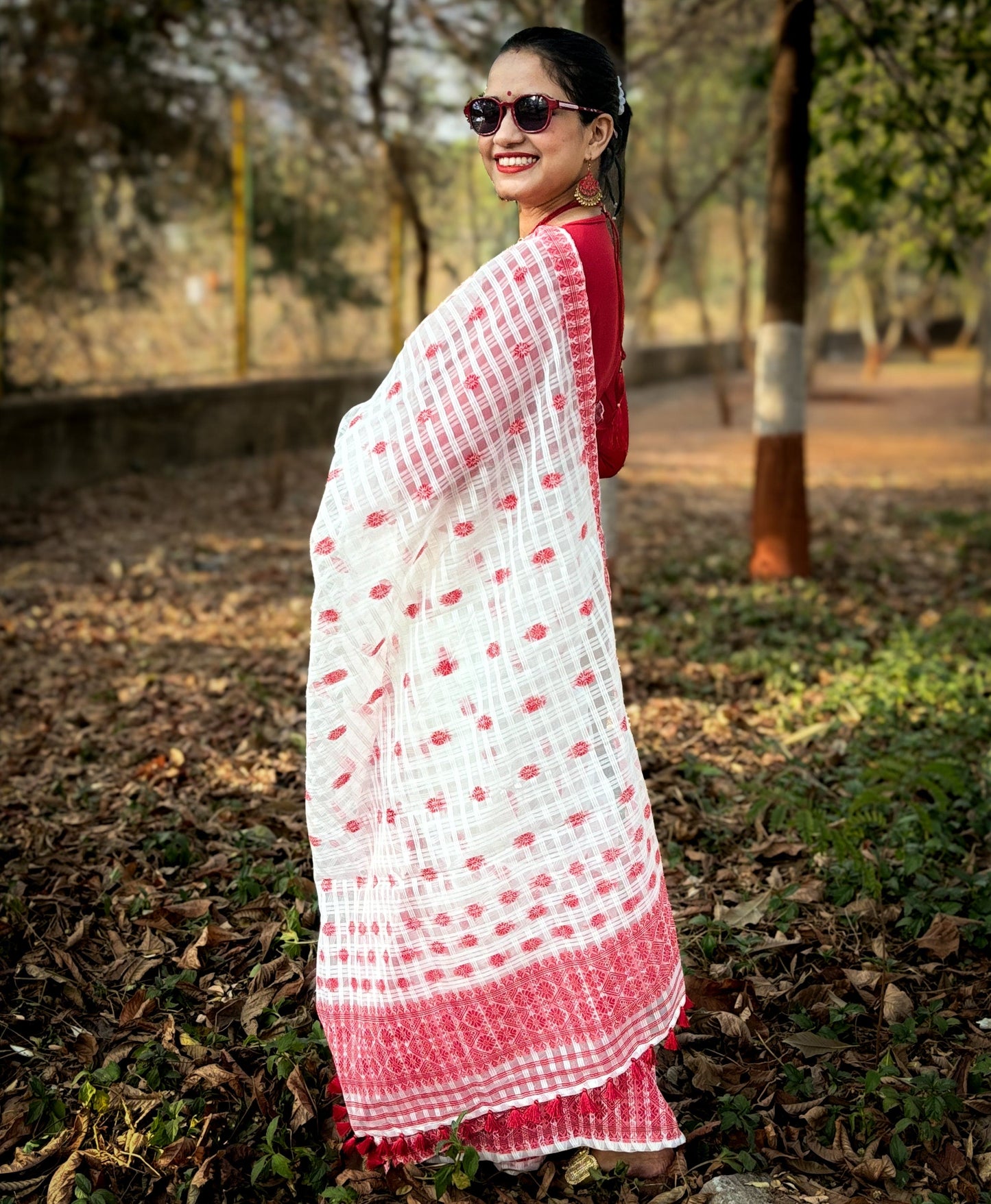 White and red cotton Mekhela Chador from Assam with traditional woven motifs, ideal for Bihu and Assamese festive wear