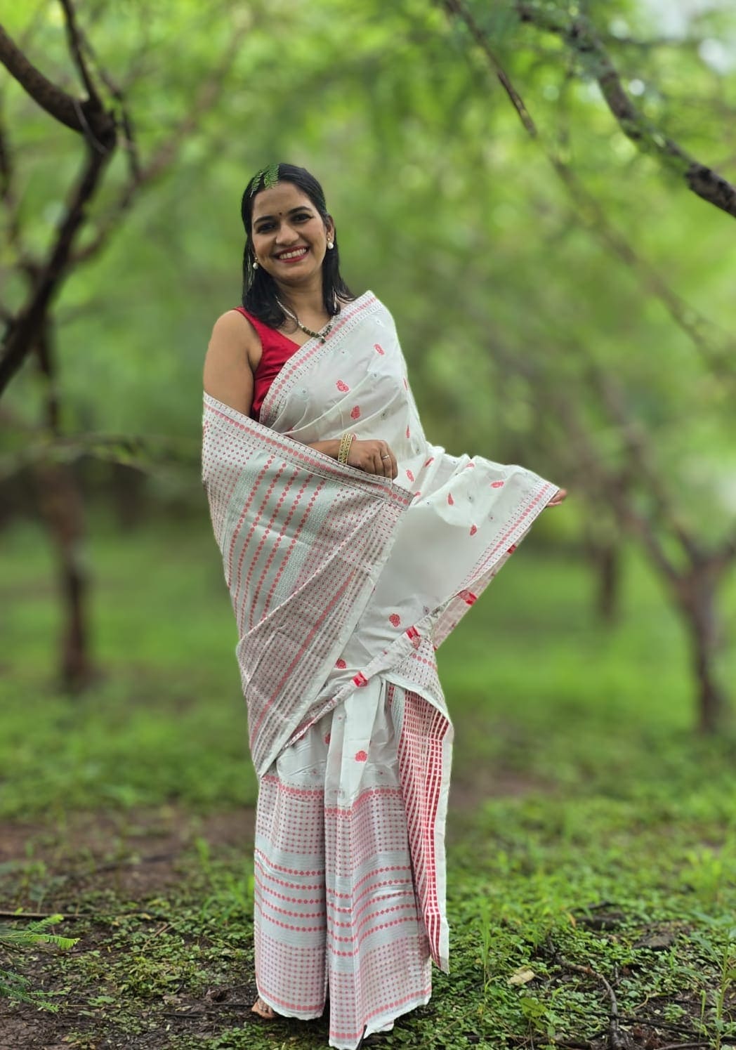 Handwoven silk cotton Mekhela Chador from Assam with traditional red motifs and border