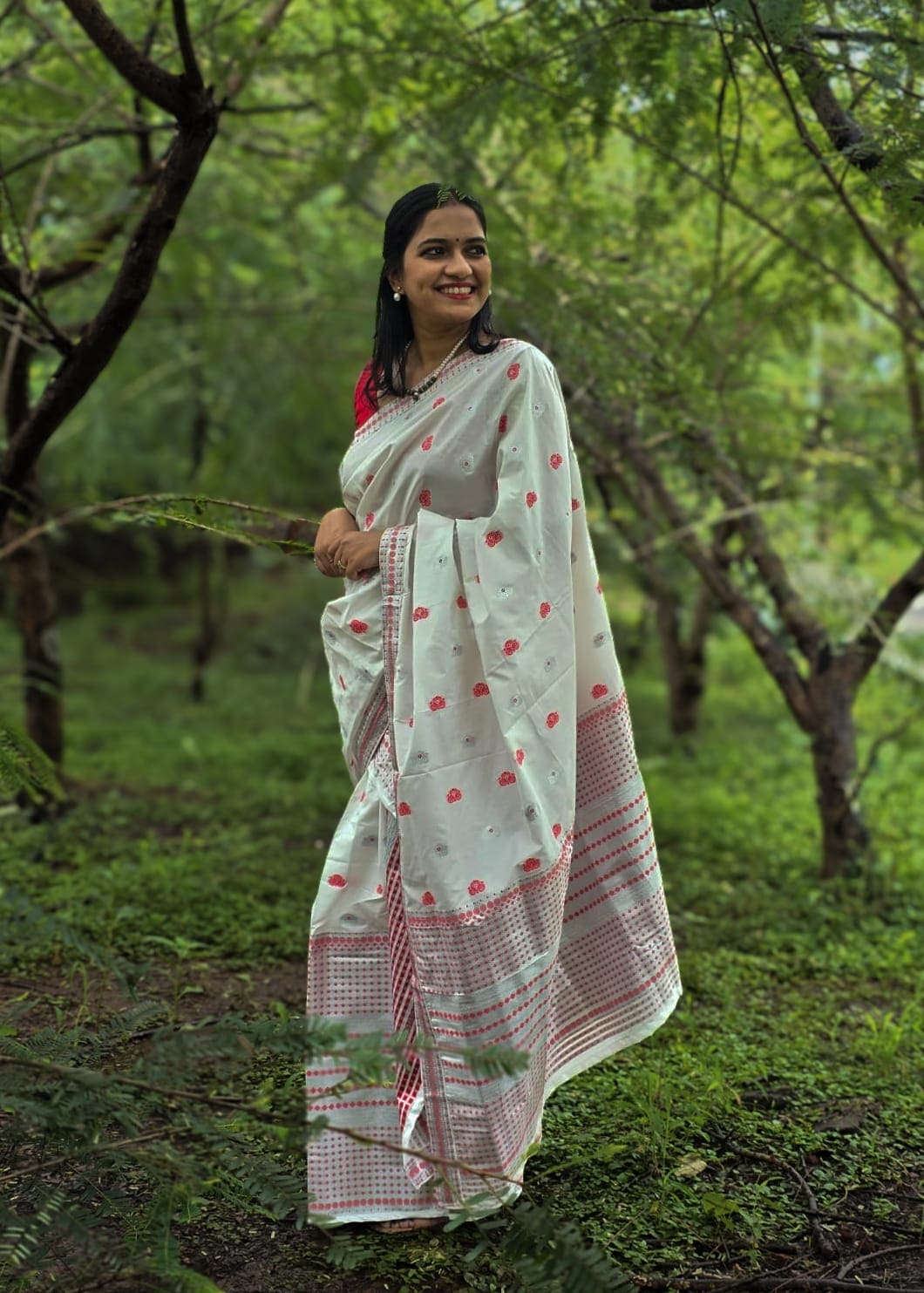 Handwoven white silk Mekhela Chador from Assam with traditional red motifs and border