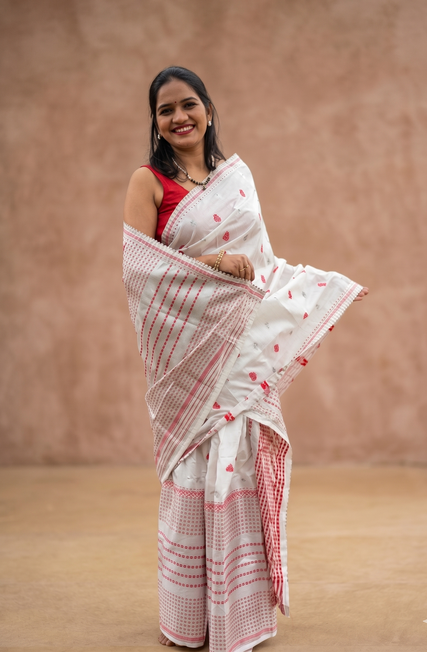 Rongili Xuworoni white silk blend Mekhela Chador with red motifs fully stitched and ready to wear from Assam by Apaapi