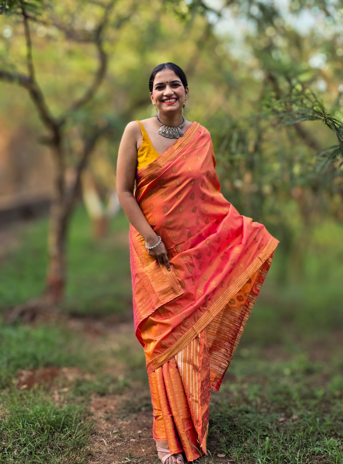 Handwoven orange silk Mekhela Chador from Assam with traditional woven motifs