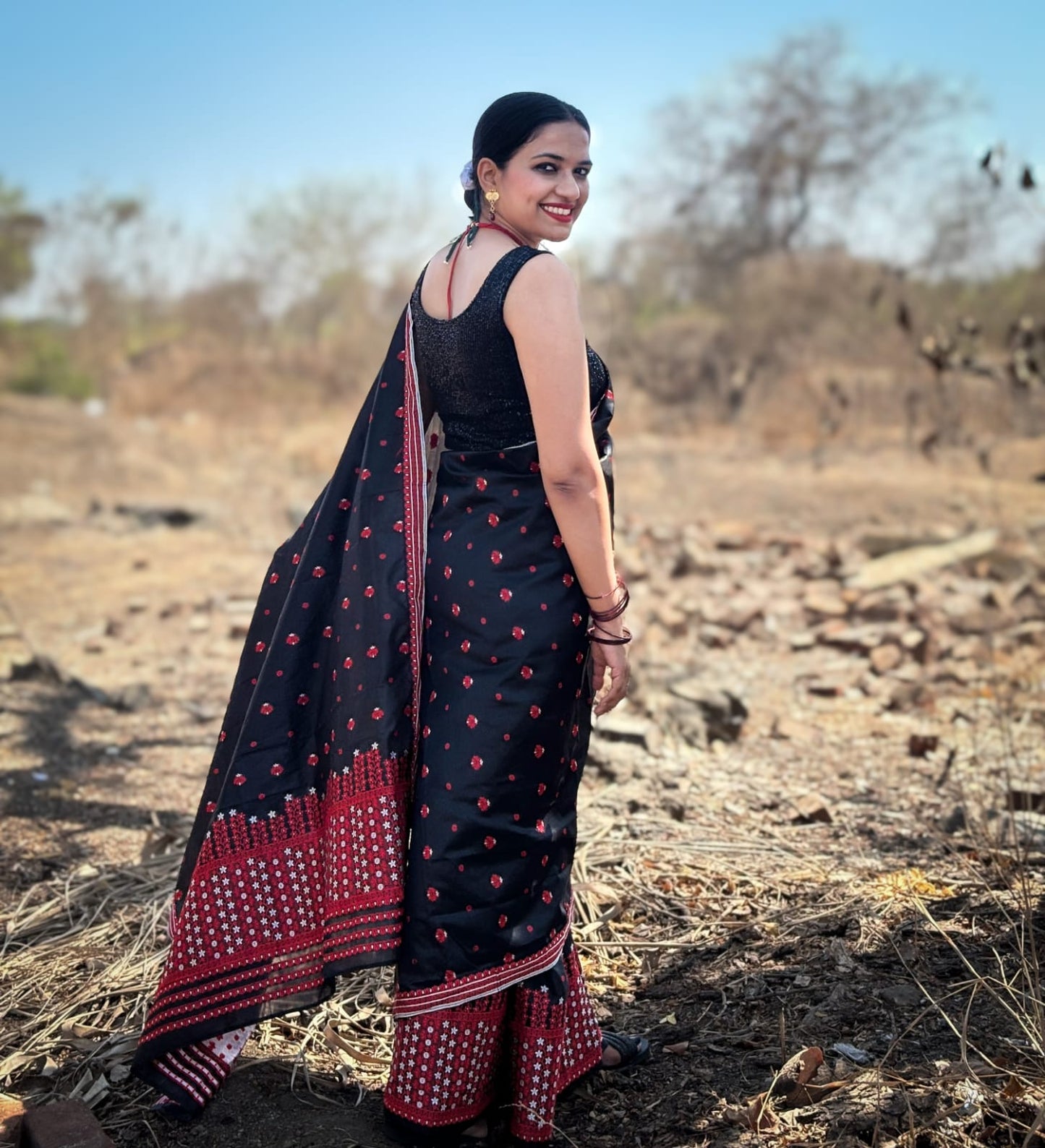 Black and red silk cotton Mekhela Chador from Assam with traditional woven motifs and festive border detailing