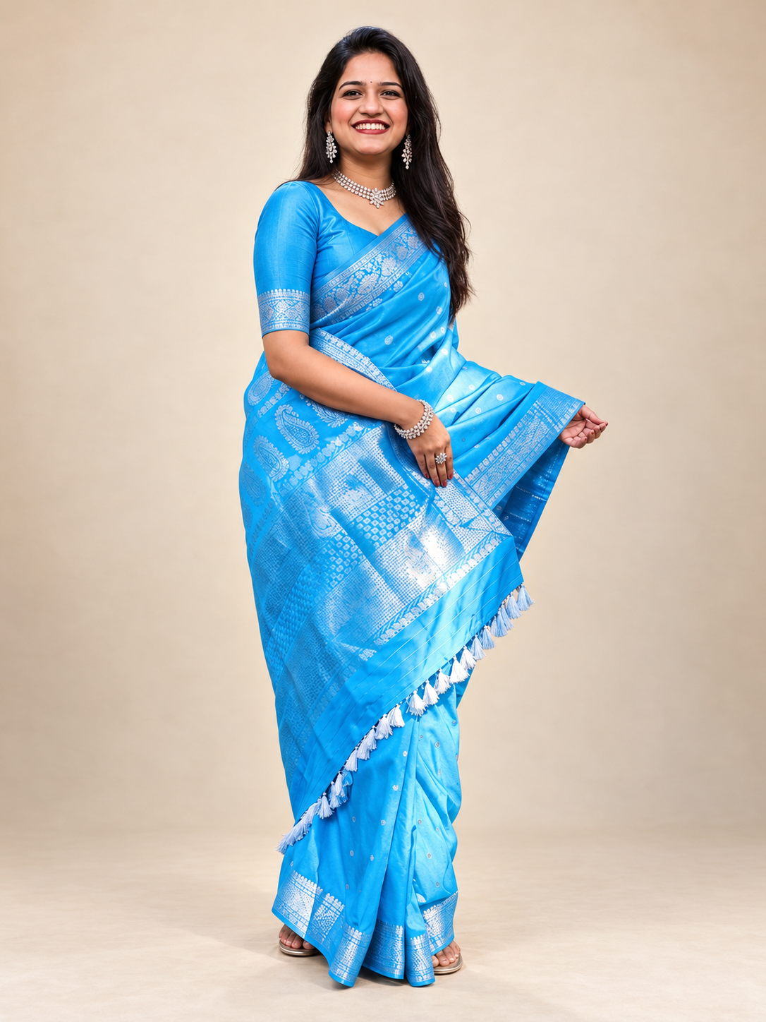Sky blue saree with silver patterned pallu and decorative border styled for Indian cultural gatherings and festive wear.