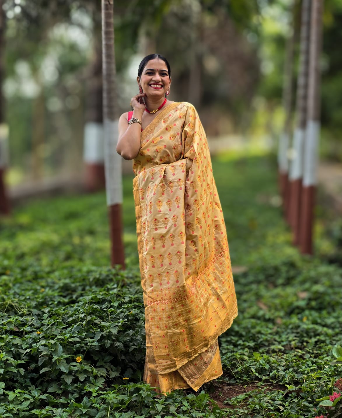 Handwoven golden yellow silk Mekhela Chador from Assam with red floral motifs