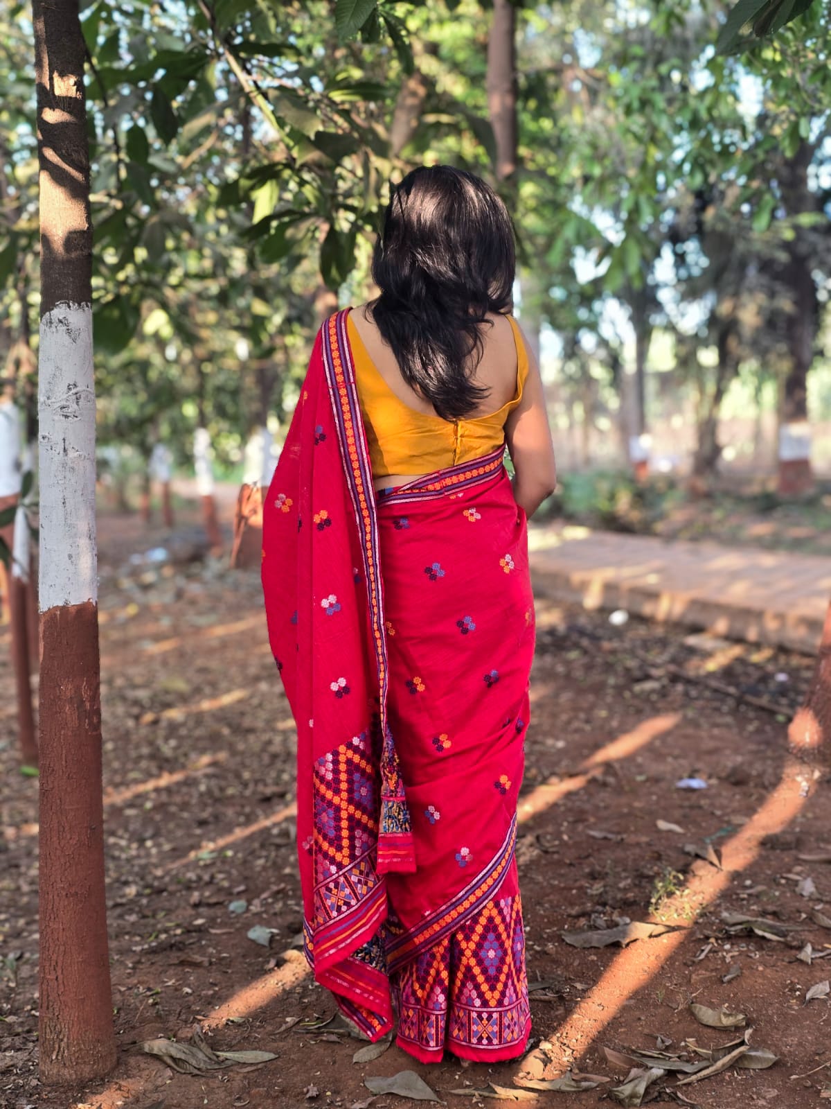 Full-length view of the Rengam Red Mishing Mekhela Chador showcasing the intricate purple and orange zig-zag 