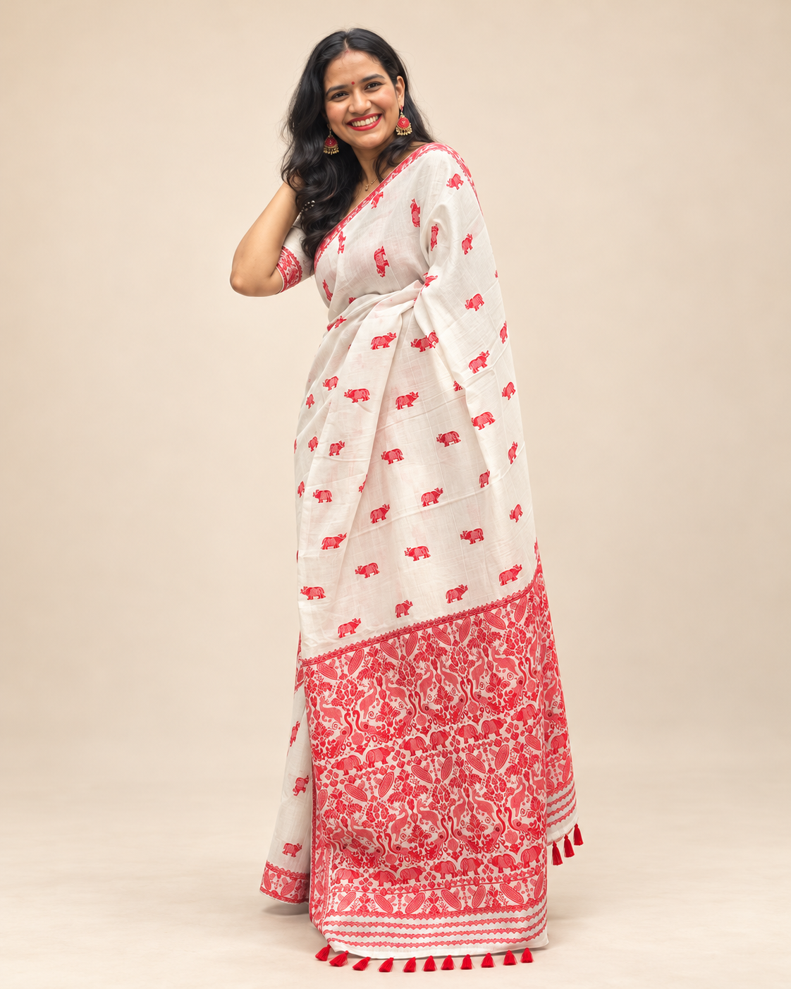 White Rhino white and red Assam saree with Kaziranga-inspired one-horned rhino motifs and detailed red pallu by Apaapi.