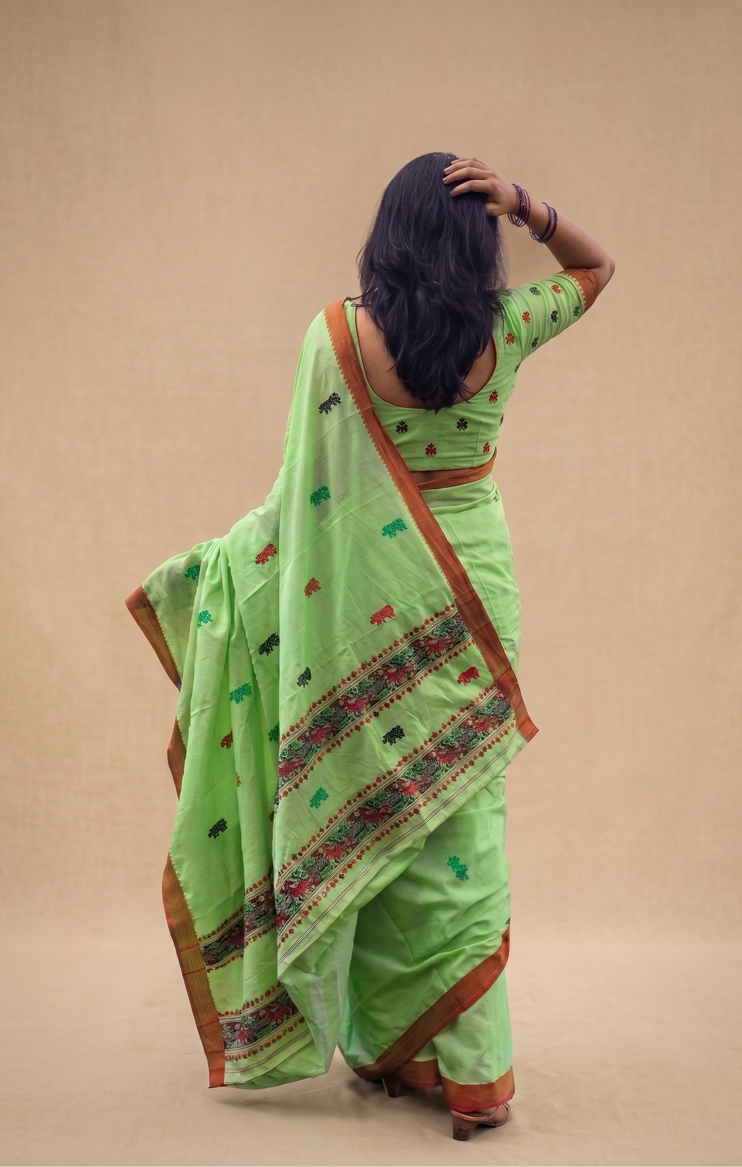 Woman wearing Kaziranga Prakriti Green Assam Cotton Saree by Apaapi, styled for festive and cultural ethnic wear.