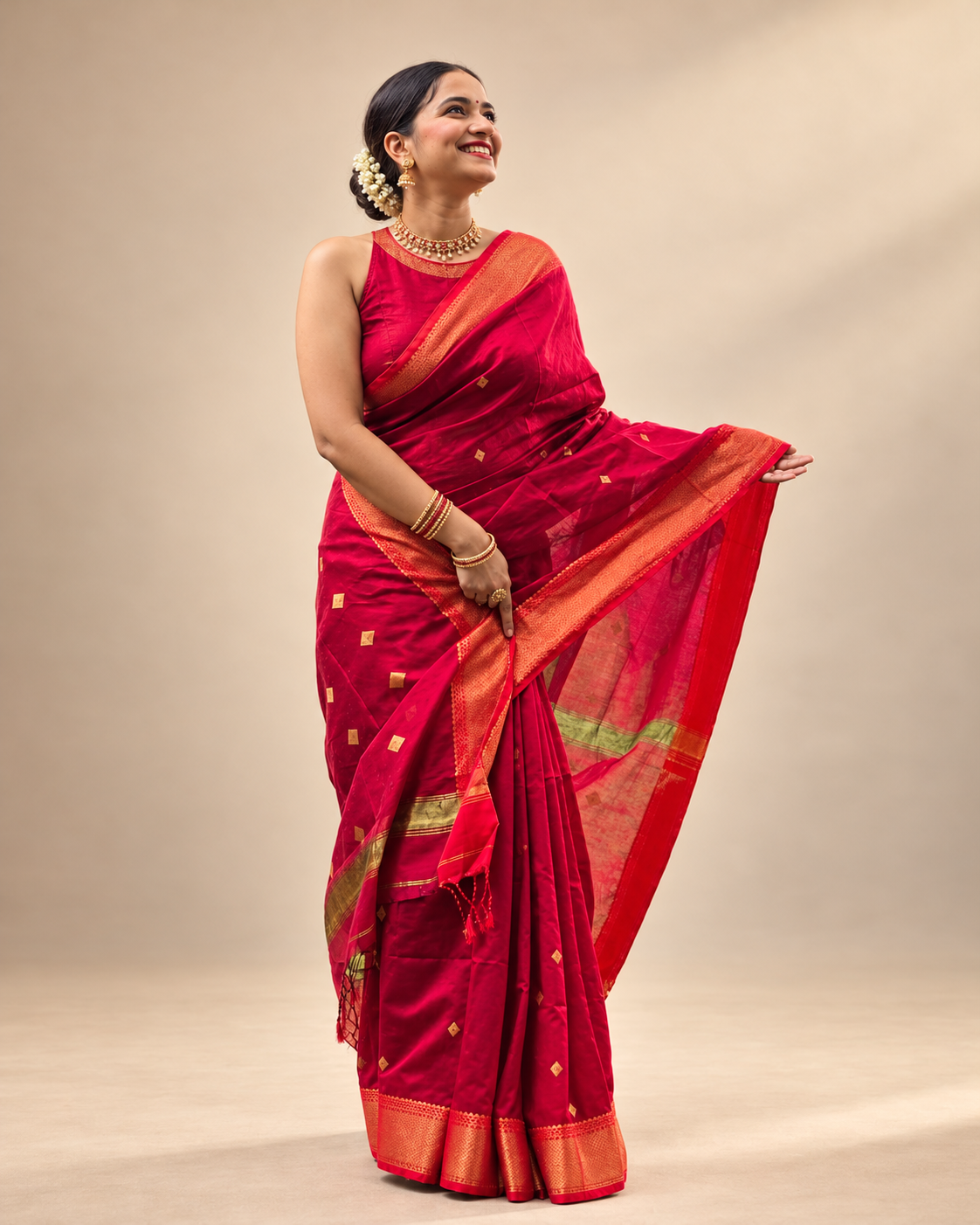 Xunmala red festive saree with small gold-toned buti motifs and broad gold border.