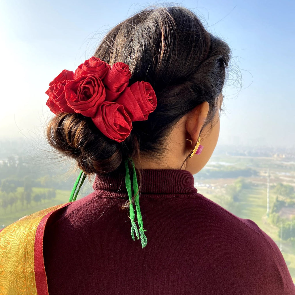 A low bridal bun tucked with Red Roses and baby breaths on a classic red  lehenga can n… | Bridal hair decorations, Bridal hair buns, Bridal hairstyle  indian wedding