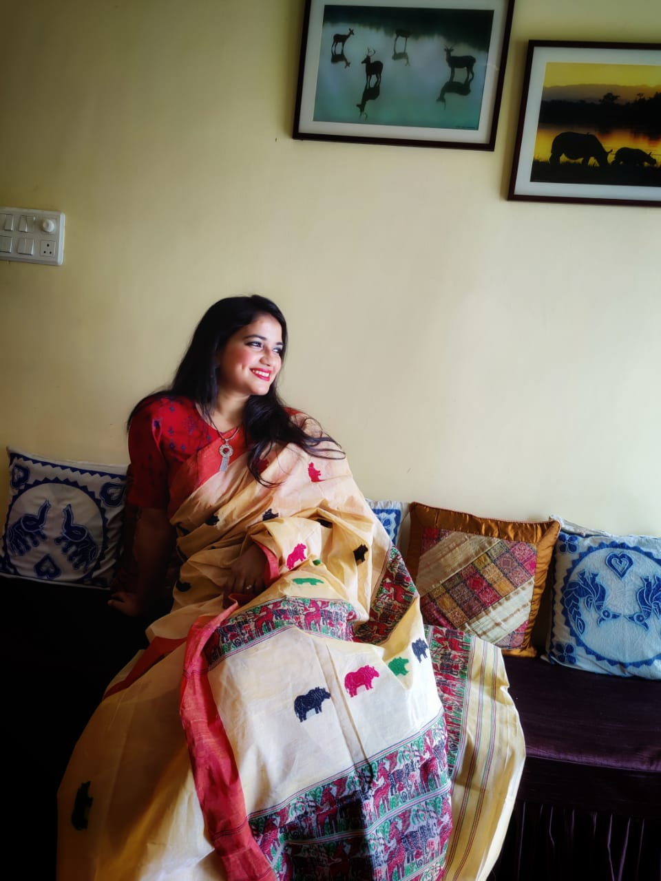 Woman wearing Rhino Wrinkles Kaziranga Saree by Apaapi, an Assam-inspired saree with one-horned rhino and Kaziranga nature storytelling.